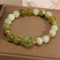 Women's jade bracelet in Xiuyan jade green colour with original design on wrist.