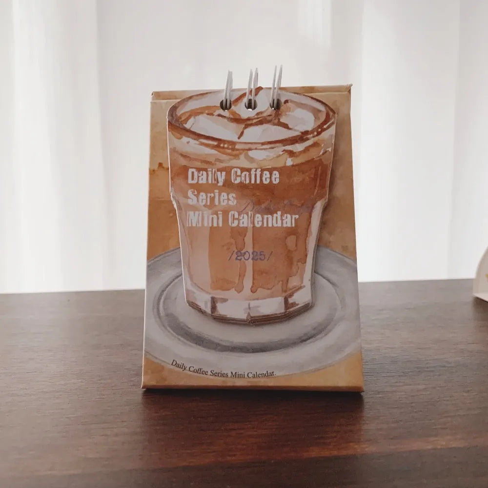 Mini 2025 desk calendar showing multiple design options including Coffee Time and Life Is Not Easy themes