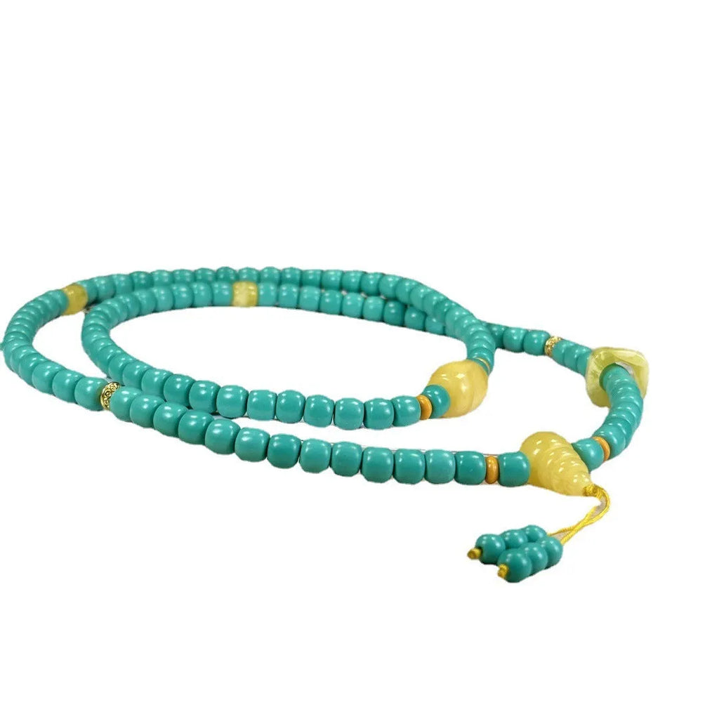 Turquoise mesh flower lucky pendant necklace with ball bead chain on a white background