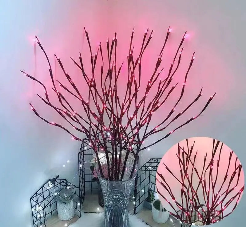 LED decorative tree light with silver branches in a vase, emitting coloured light.