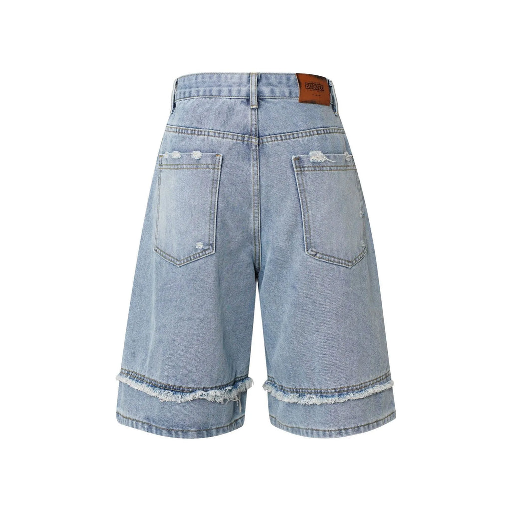 Distressed raw edge denim shorts in straight leg cropped fit.