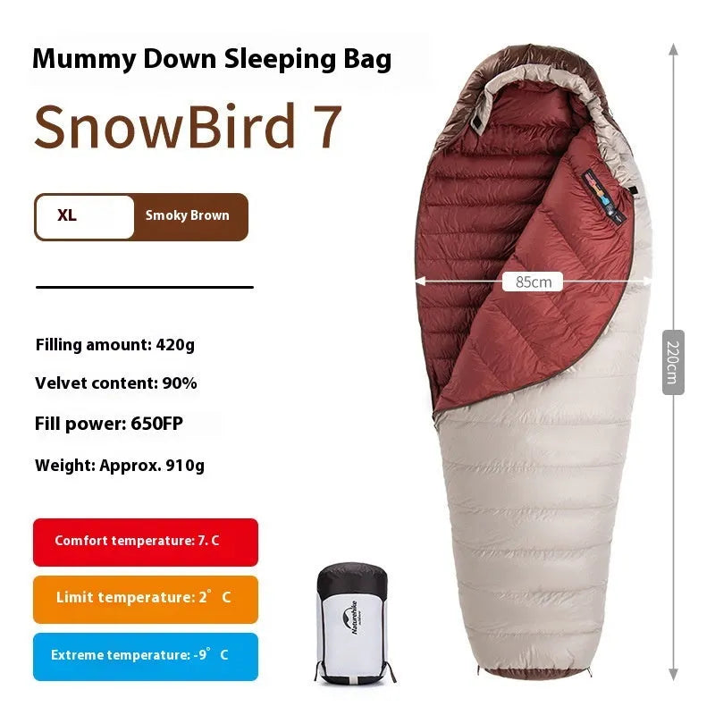 Mummy style goose down sleeping bag for adults shown with its storage bag
