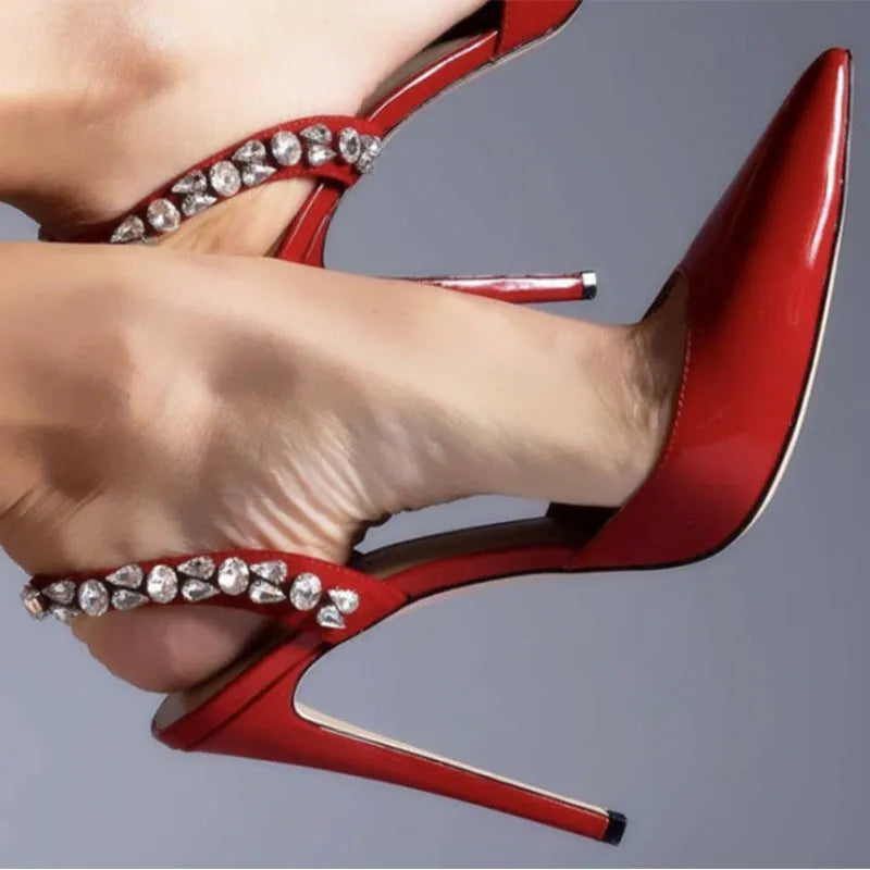 Women's black patent leather pointed toe high heel sandals with rhinestone details on the strap.