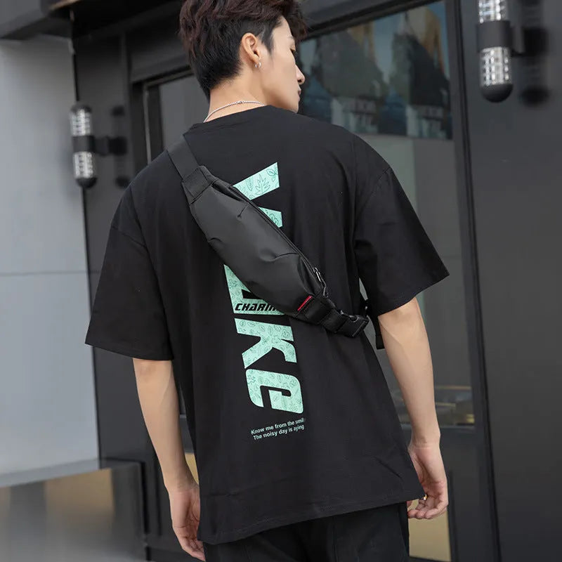 Black oxford cloth tactical crossbody bag showing front zipper and compact size.