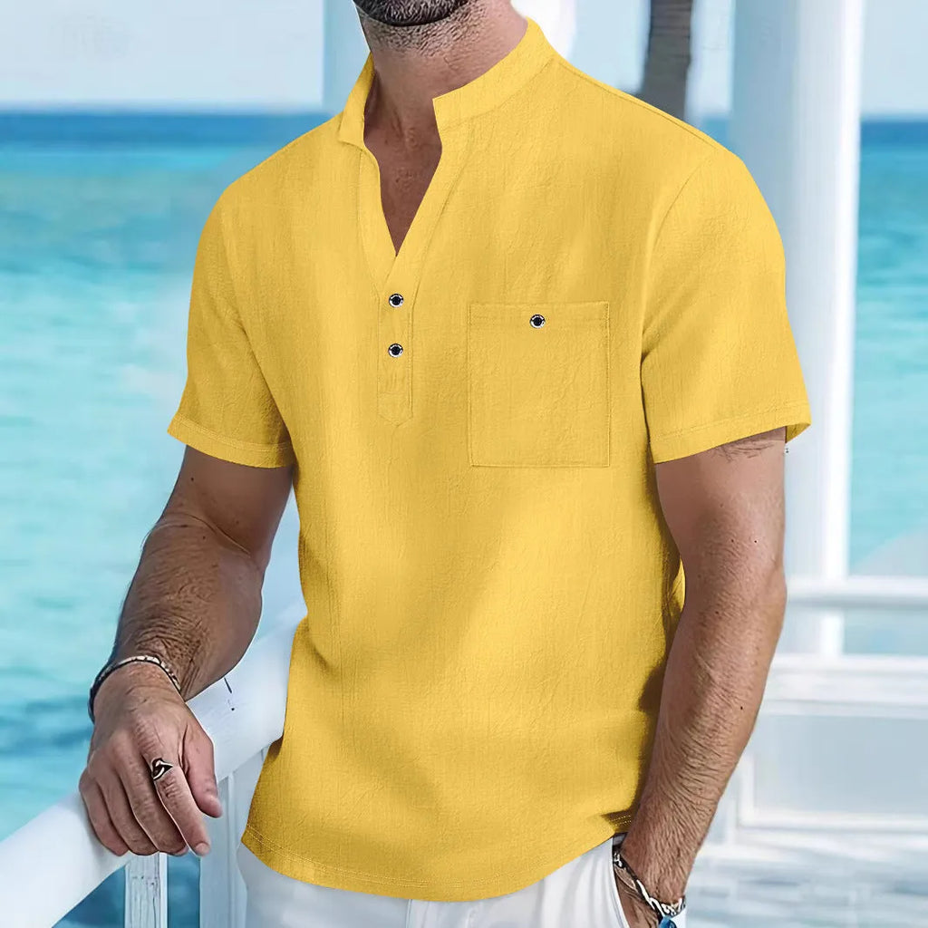 Man's light blue linen blend t-shirt with stand collar and short sleeves in a loose fit.