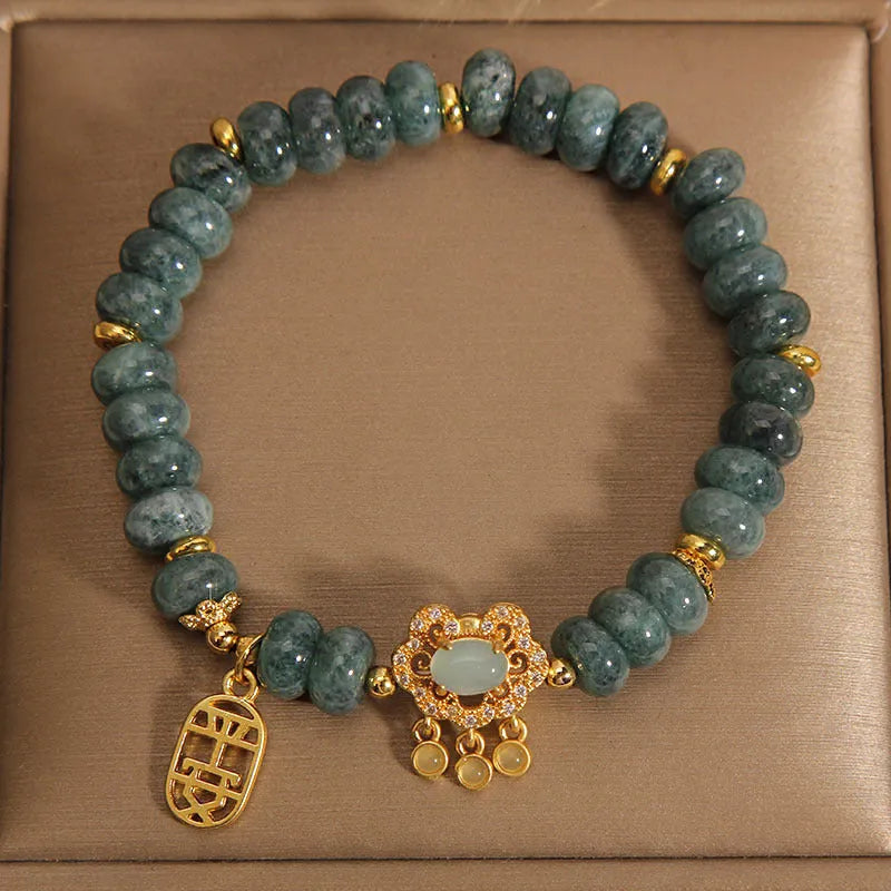 Natural emerald green jade abacus beads bracelet with a metallic alloy safety lock clasp.
