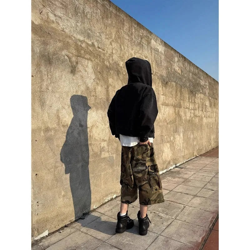 Men's camouflage coloured cropped jeans with ripped detailing and retro patch accents