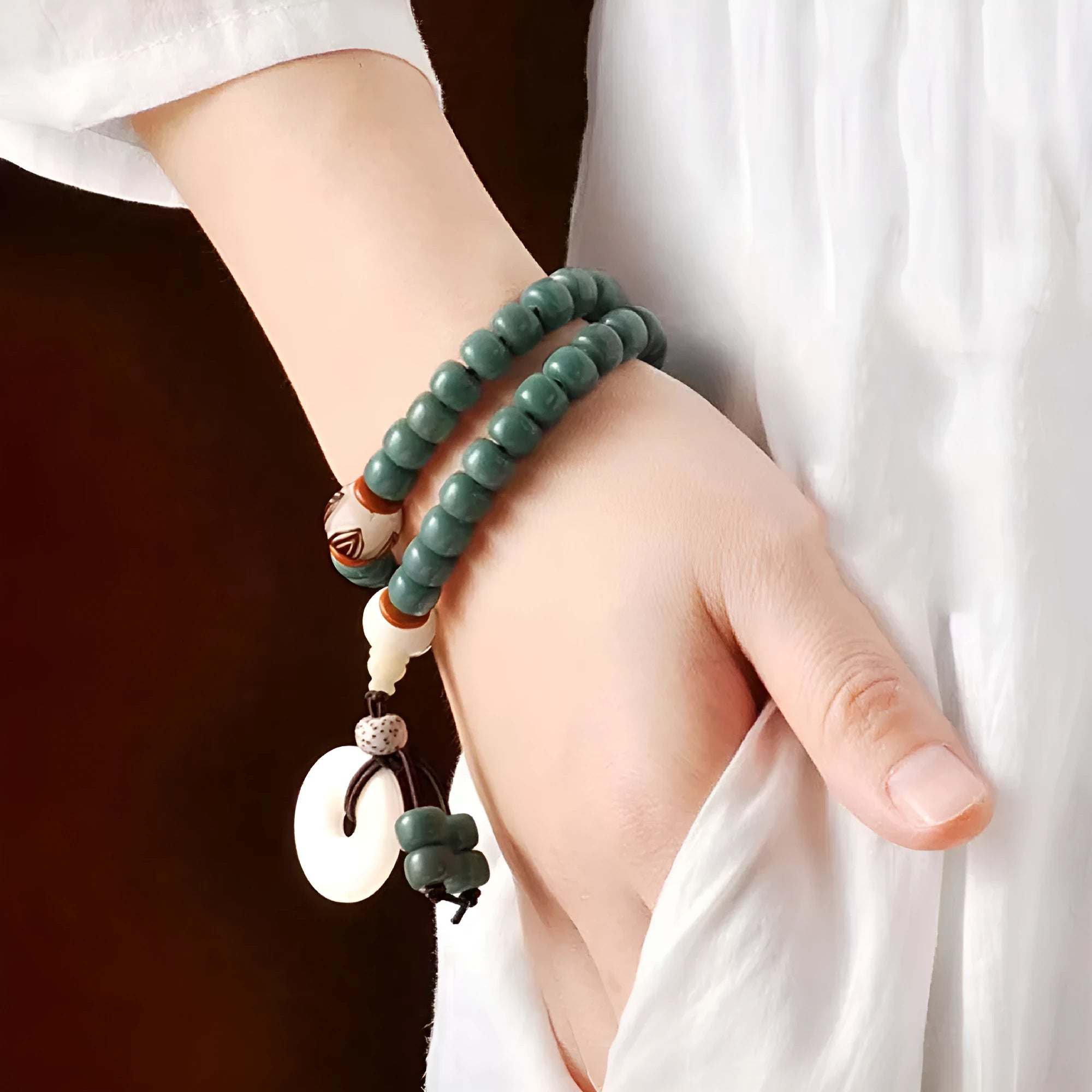 Bodhi seed bracelet with double ring safety buckle and lotus design on round beads