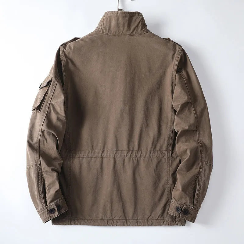 Man wearing a loose-fit light brown cotton twill retro jacket with a zip front.