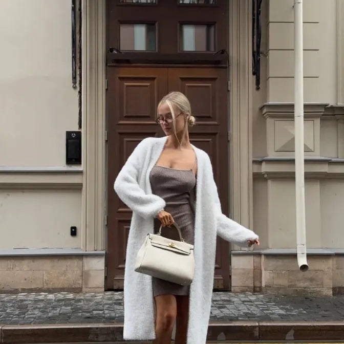 White thick knitted women's cardigan jacket with extended length and loose fit design