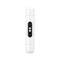 White portable electric armpit hair trimmer with USB cable on pink background