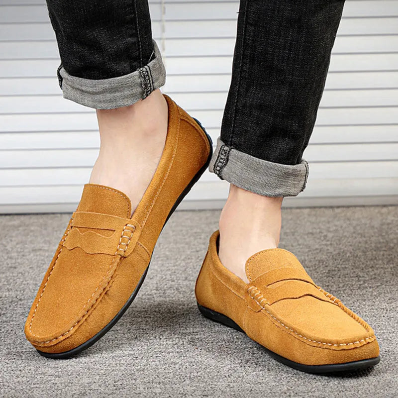 Men's solid colour suede leather slip-on loafers with round toe and flat rubber sole.