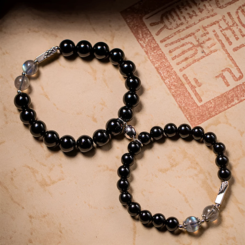 Obsidian Buddha beads couple bracelet set showing 8mm women's and 10mm men's sizing differences