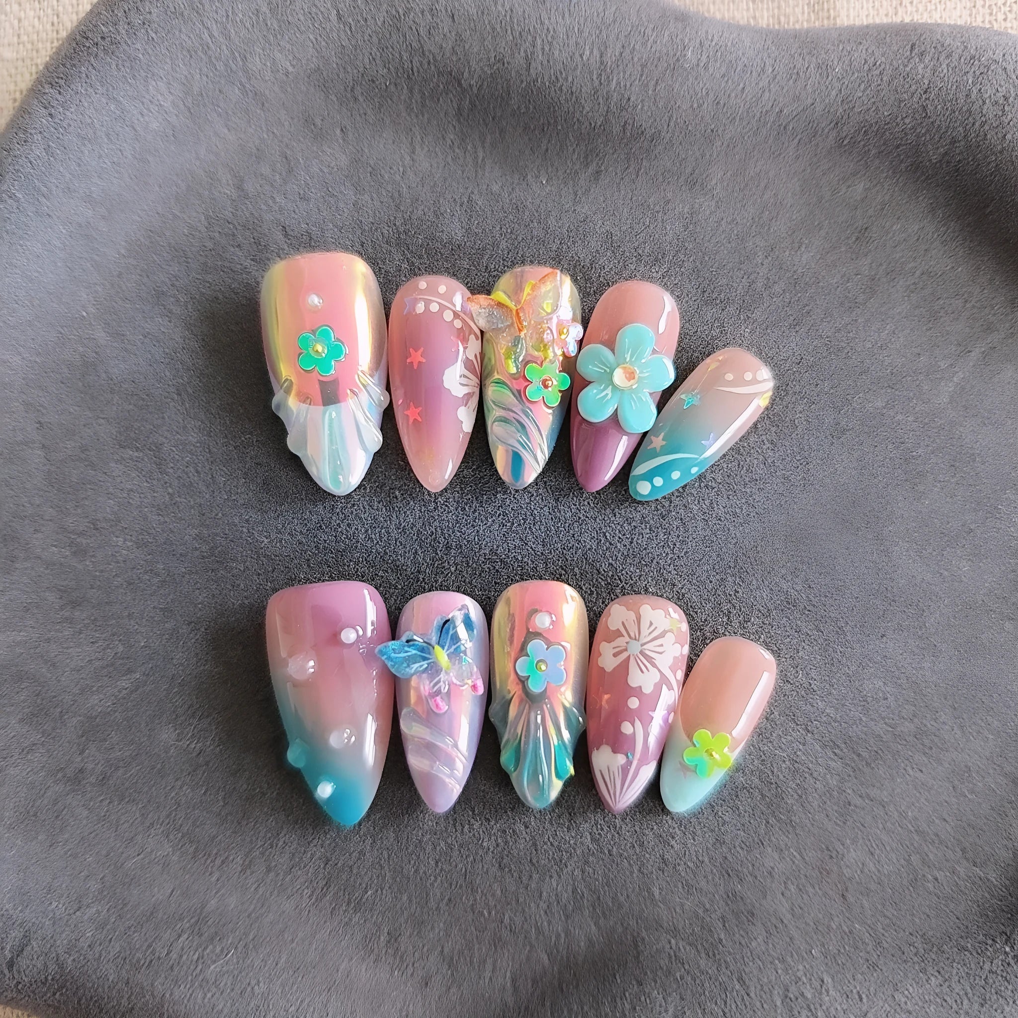 Handmade sculpture manicure set with colourful embossed flower and butterfly patterns on almond shaped nails