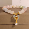 Close-up of a women's adjustable crystal bracelet with a colourful Morganite butterfly pendant.