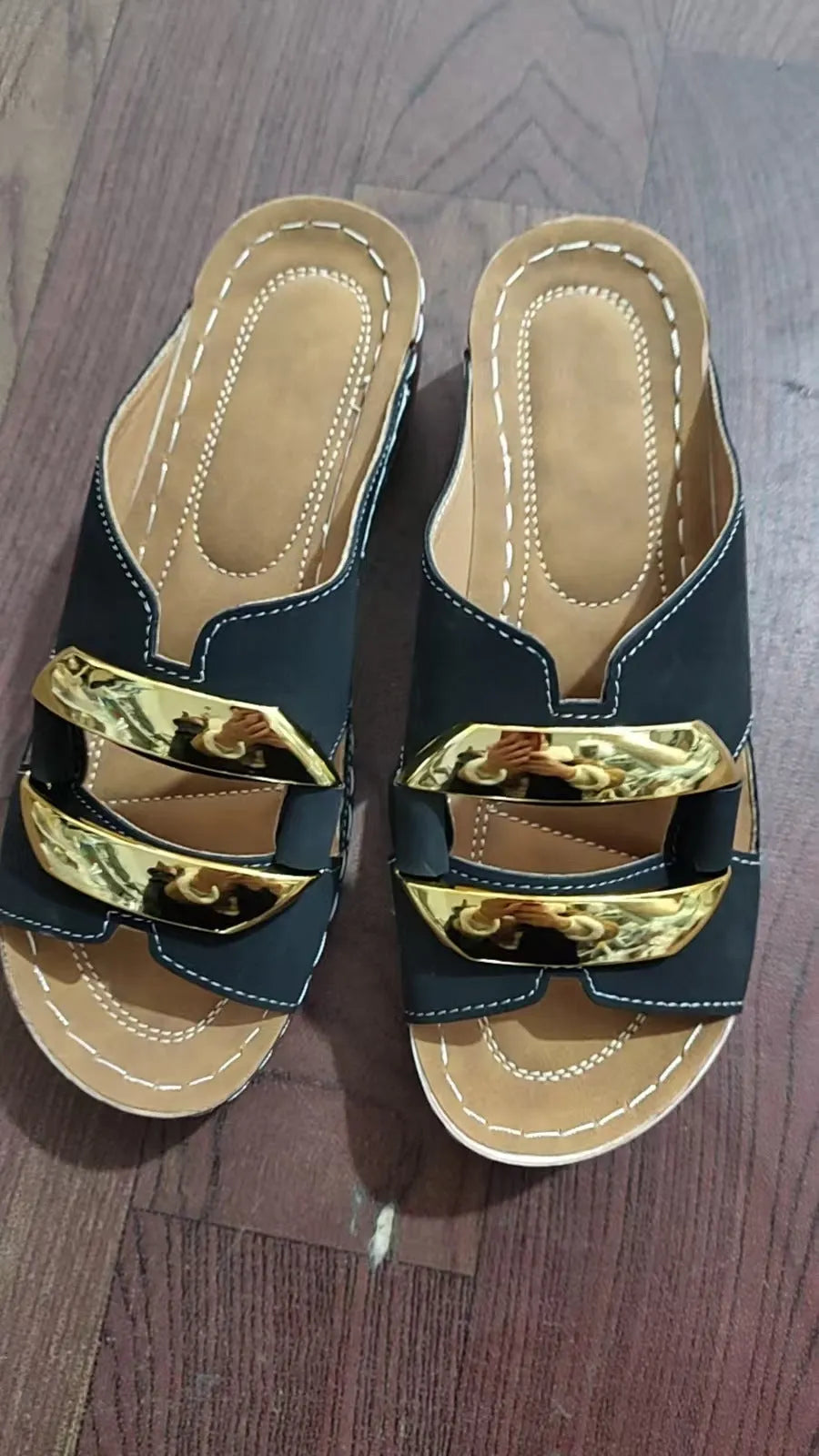 Men's white Roman-style platform sandals with a flat rubber sole and decorative metal details on the strap.