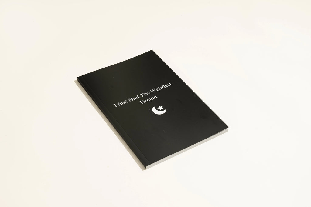 Black hardcover dream journal notebook with dot grid paper for dream recording