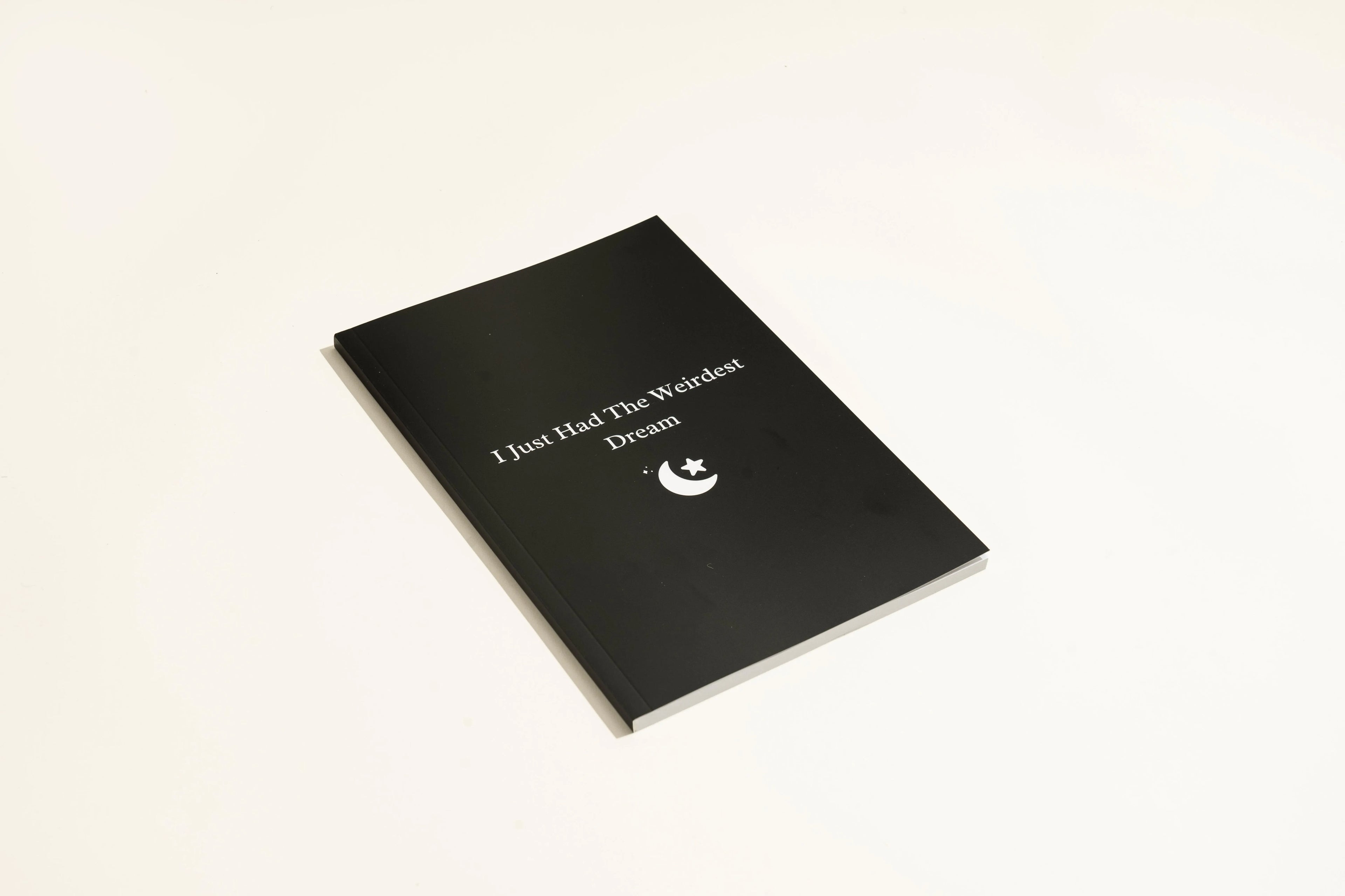 Black hardcover dream journal notebook with dot grid paper for dream recording