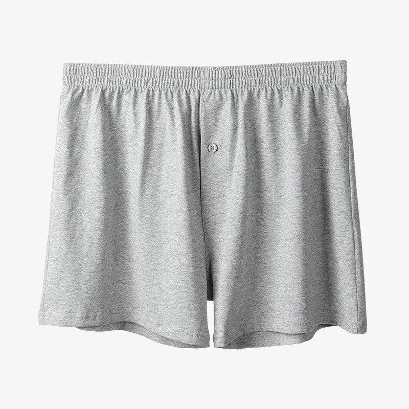 Men's solid colour cotton boxer shorts with a high waist and loose fit on a neutral background.