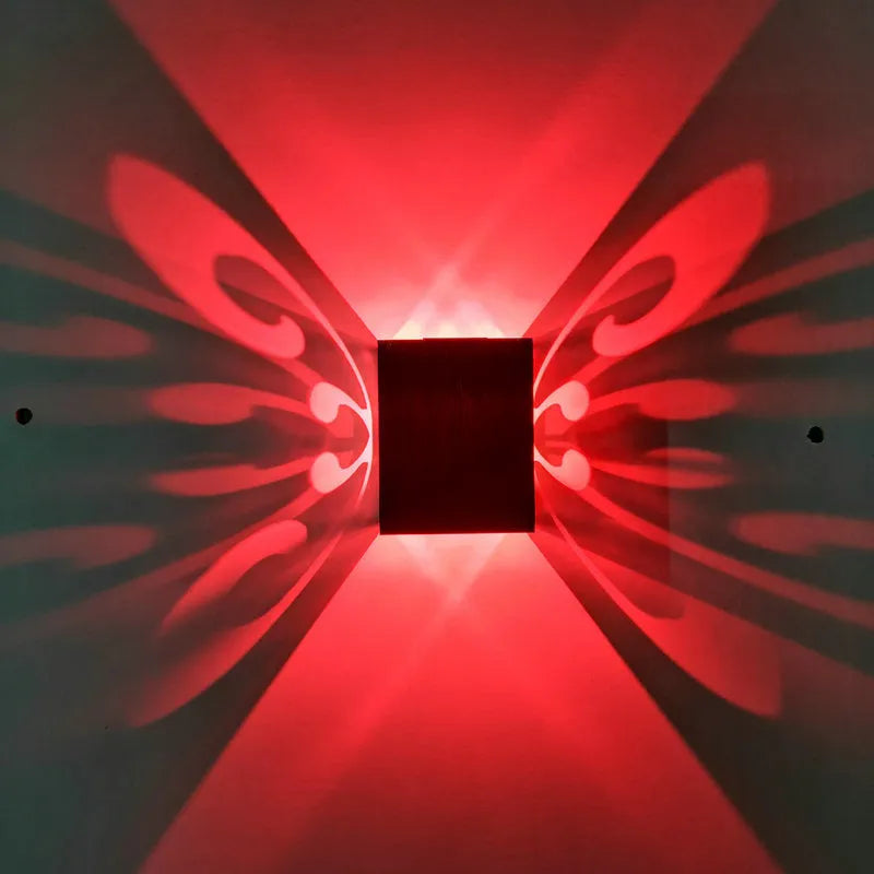 Modern aluminium butterfly-shaped LED wall lamp with remote control for changing light colours.