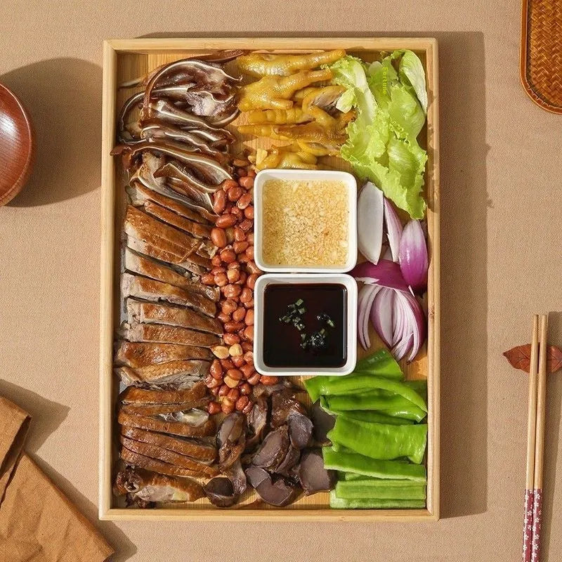 Brown handle square bamboo serving tray on a table.