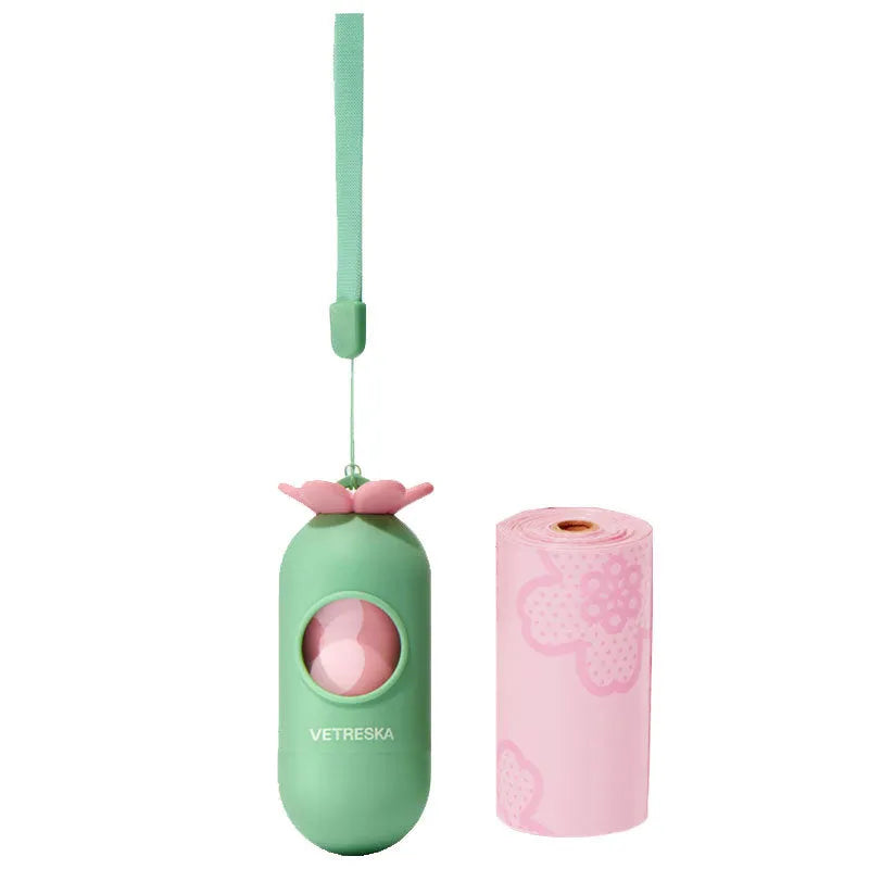 Portable dog poop bag dispenser capsule in strawberry design with a roll of fragranced bags.
