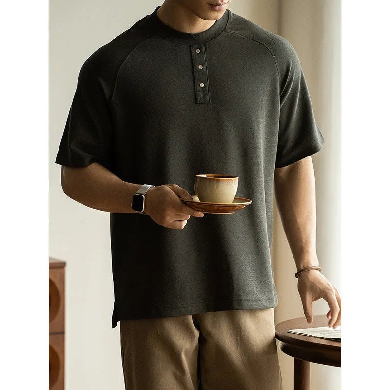 Casual loose-fitting pullover top with raglan sleeves in a terry texture fabric.