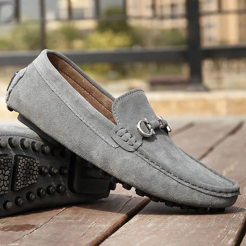 Men's black slip-on cowhide leather shoes with square toe and visible stitching on a rubber sole.
