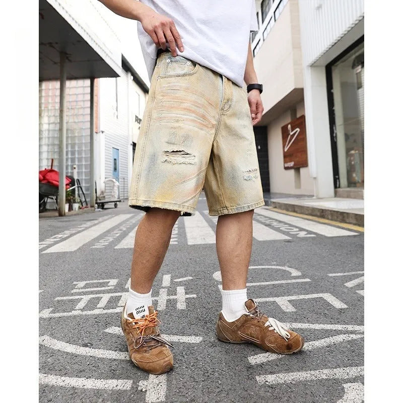 Men's light blue ripped denim shorts with straight leg style and mid-waist fit
