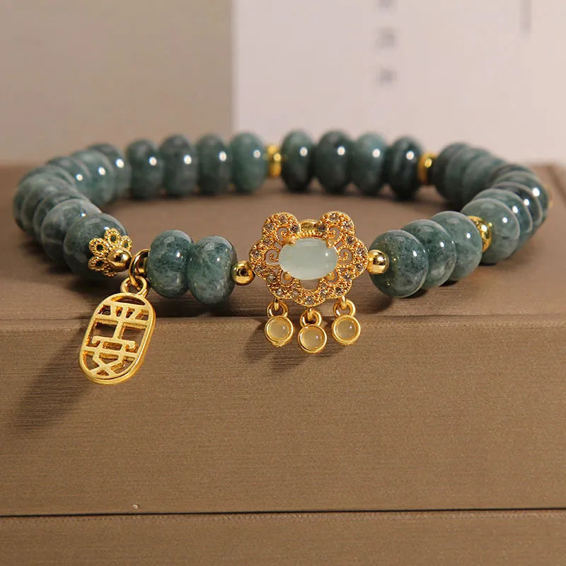 Natural emerald green jade abacus beads bracelet with a metallic alloy safety lock clasp.