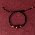 Cinnabar safety buckle bracelet with heart-shaped charm on rope cord