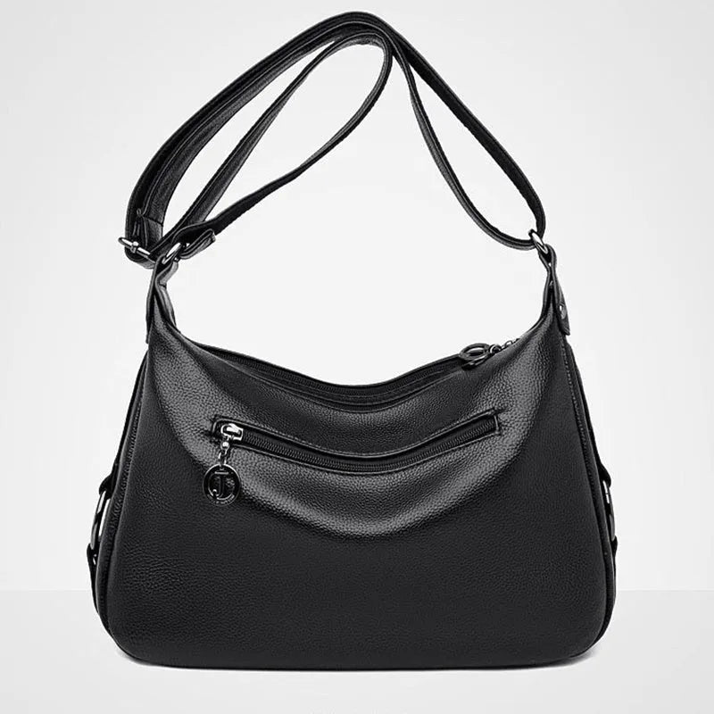 Large blue women's crossbody shoulder bag with a zipper and soft handle, shown with internal organiser pockets.