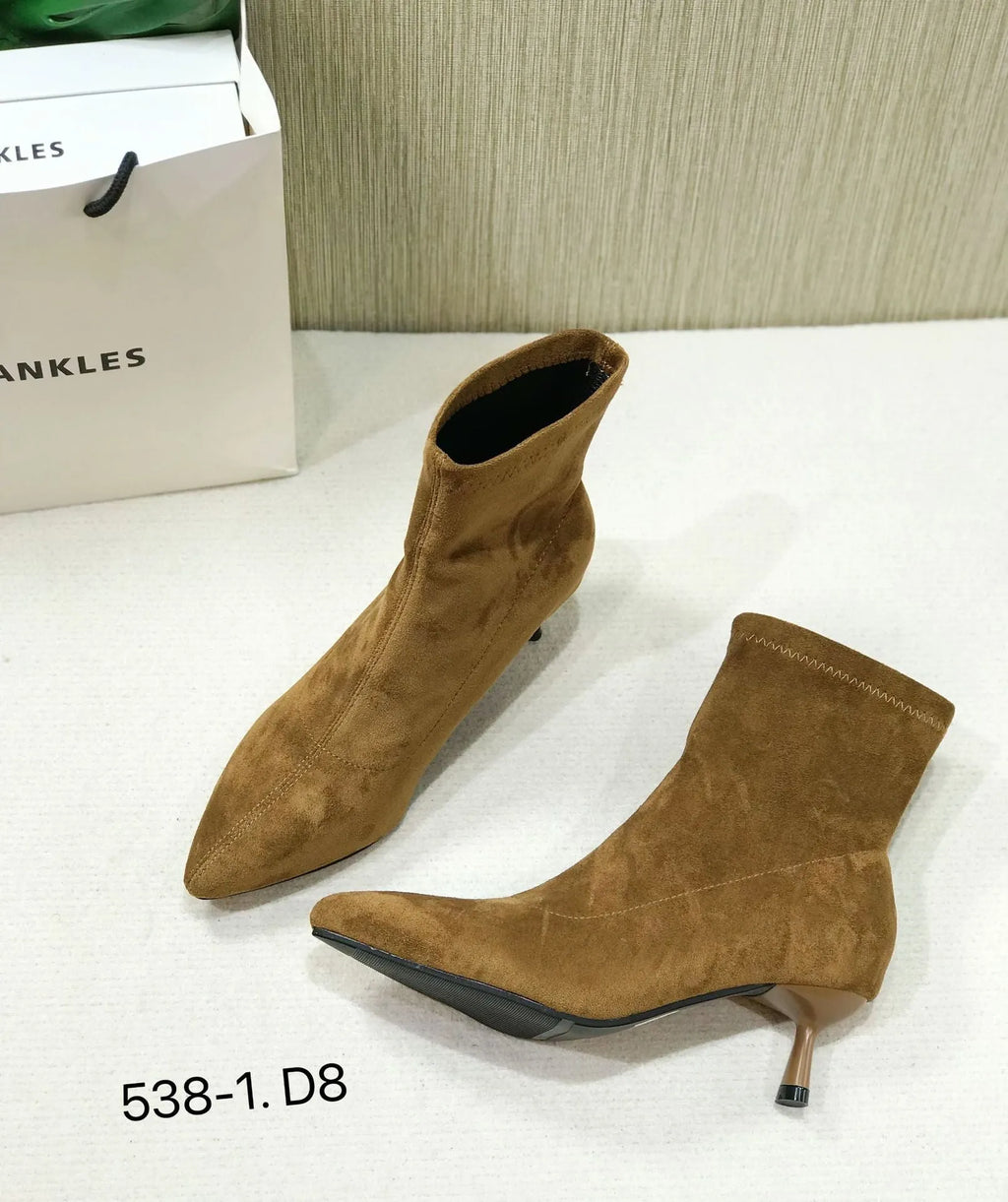 Women's black pointed toe ankle boots with stiletto heels and mid-calf length