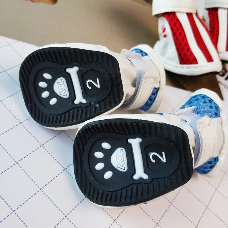 Four blue cloth dog shoes for small dogs with zipper closures on a white background.