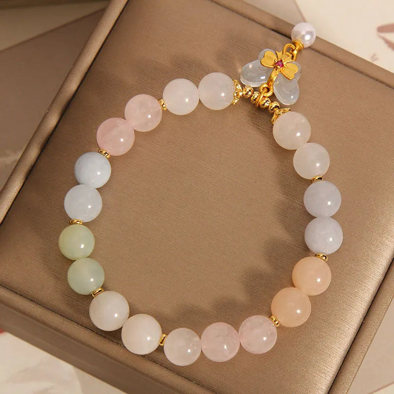 Close-up of a women's adjustable crystal bracelet with a colourful Morganite butterfly pendant.