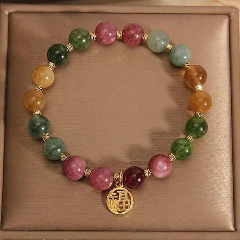 Natural colour tourmaline bracelet with floral and fu character designs on geometric casual jewellery