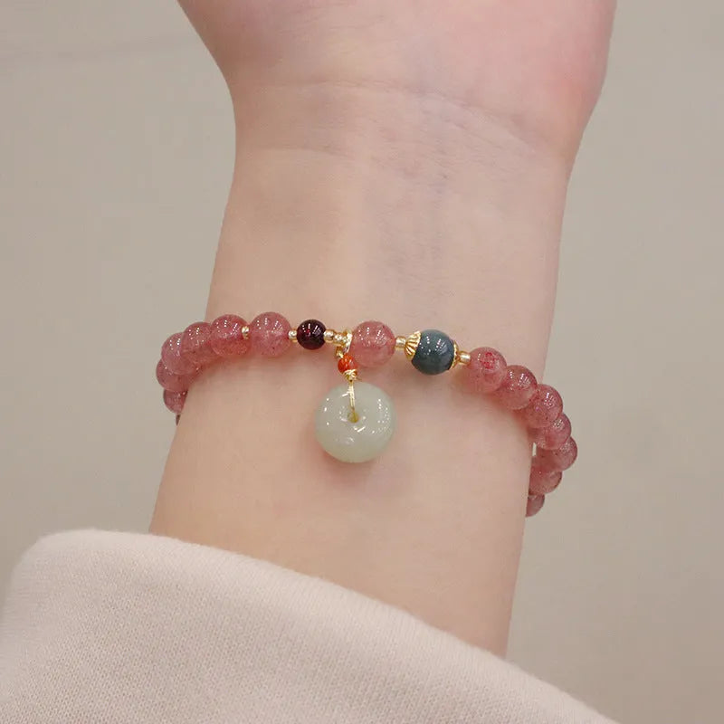 Women's geometric strawberry quartz bracelet with Chinese purse charm and safety buckle clasp.