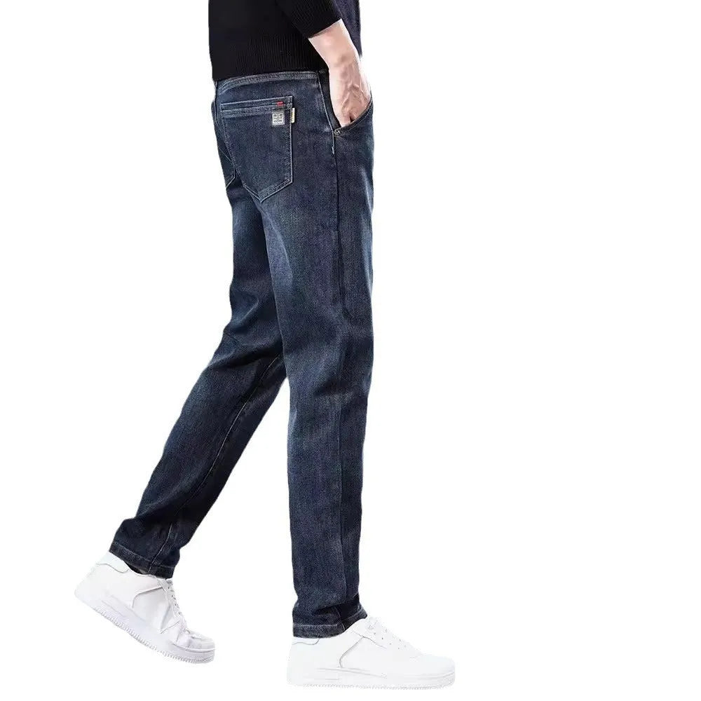 Man wearing slim straight blue grey casual trousers with a zip fly and mid waist.