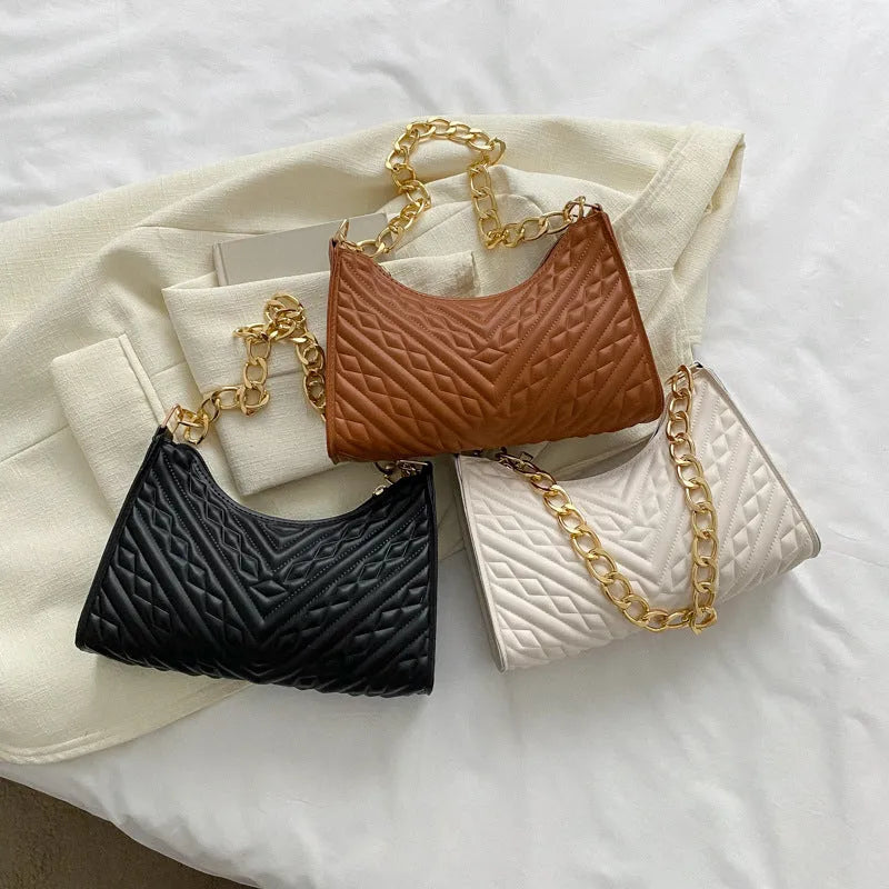 Brown pleated chain baguette shoulder bag with adjustable strap and soft carry handle