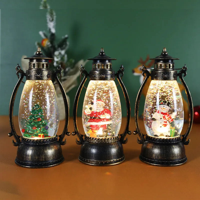 Plastic crystal ball LED oil lamp Christmas ornament with internal snowman figurine on a desktop.