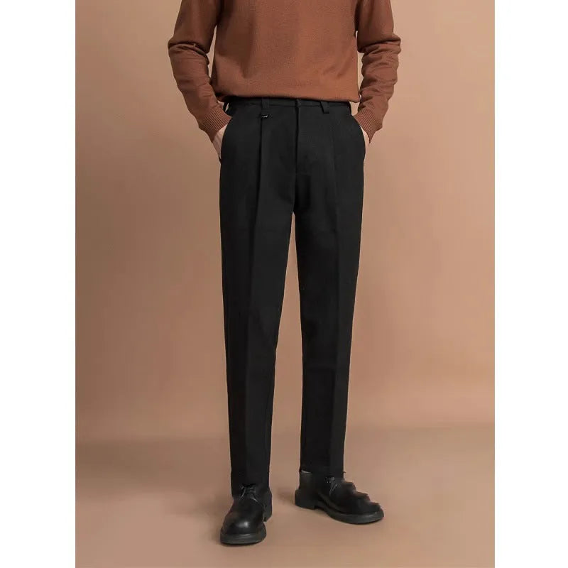 Men's straight-leg casual trousers in black, shown in a light business style setting.