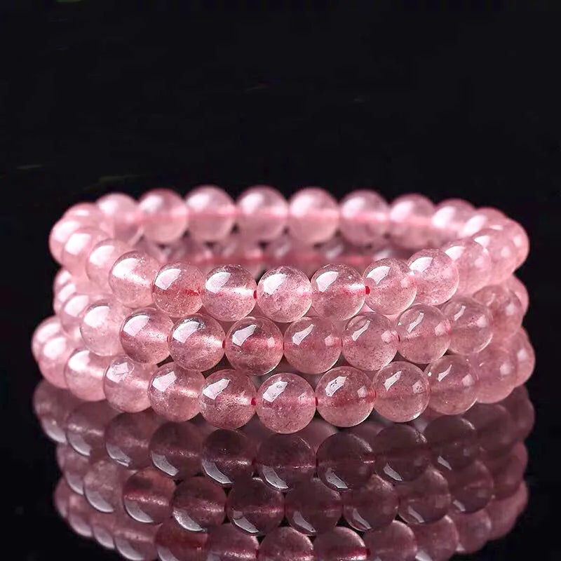 Women's strawberry quartz crystal bracelet with polished beads in 6mm, 8mm, and 10mm sizes