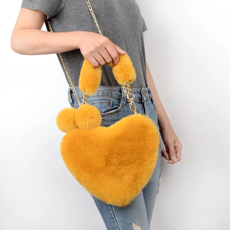 Medium soft plush heart handbag in solid color with zipper closure and shoulder strap option for women