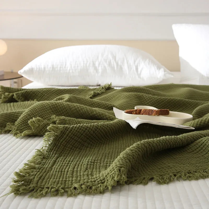 Cotton four-layer gauze blanket with tassel trim in a choice of ten colours and two sizes.