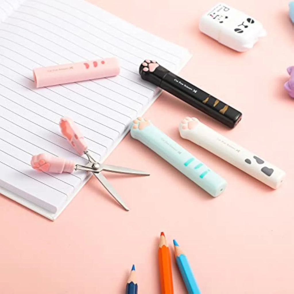 Closed folding mini scissors with cat paw design on handles in blue, pink, black, and white colour options.