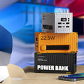 Yellow, black, and silver 50000mAh power bank with digital display showing battery level and five USB output ports.