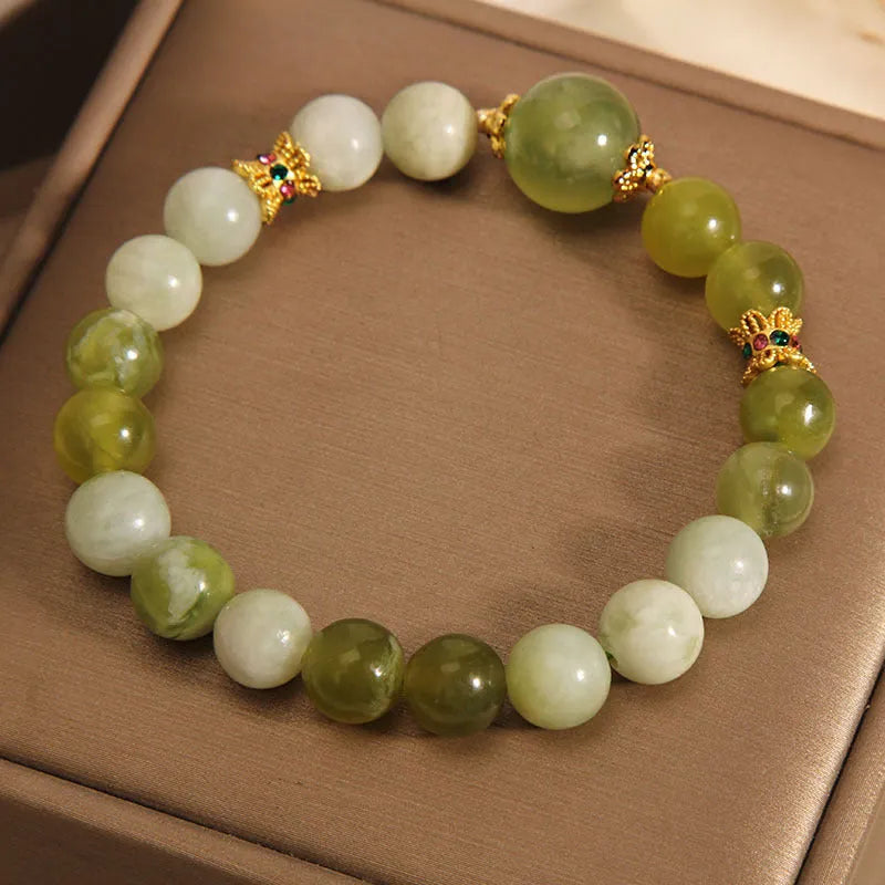 Women's jade bracelet in Xiuyan jade green colour with original design on wrist.