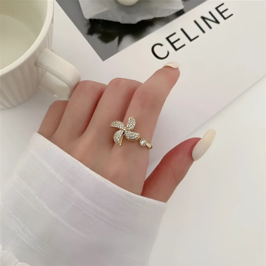 Copper micro inlaid rotating ring with geometric windmill design in gold or silver finish