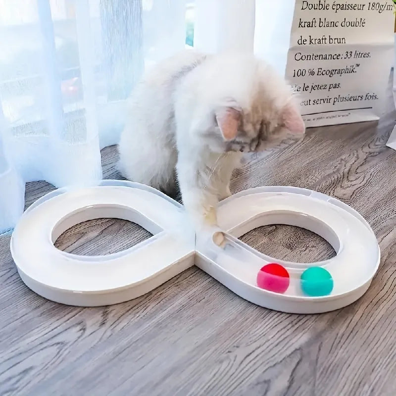 Blue and white cat turntable track ball toy with teasing stick attachment on flat surface