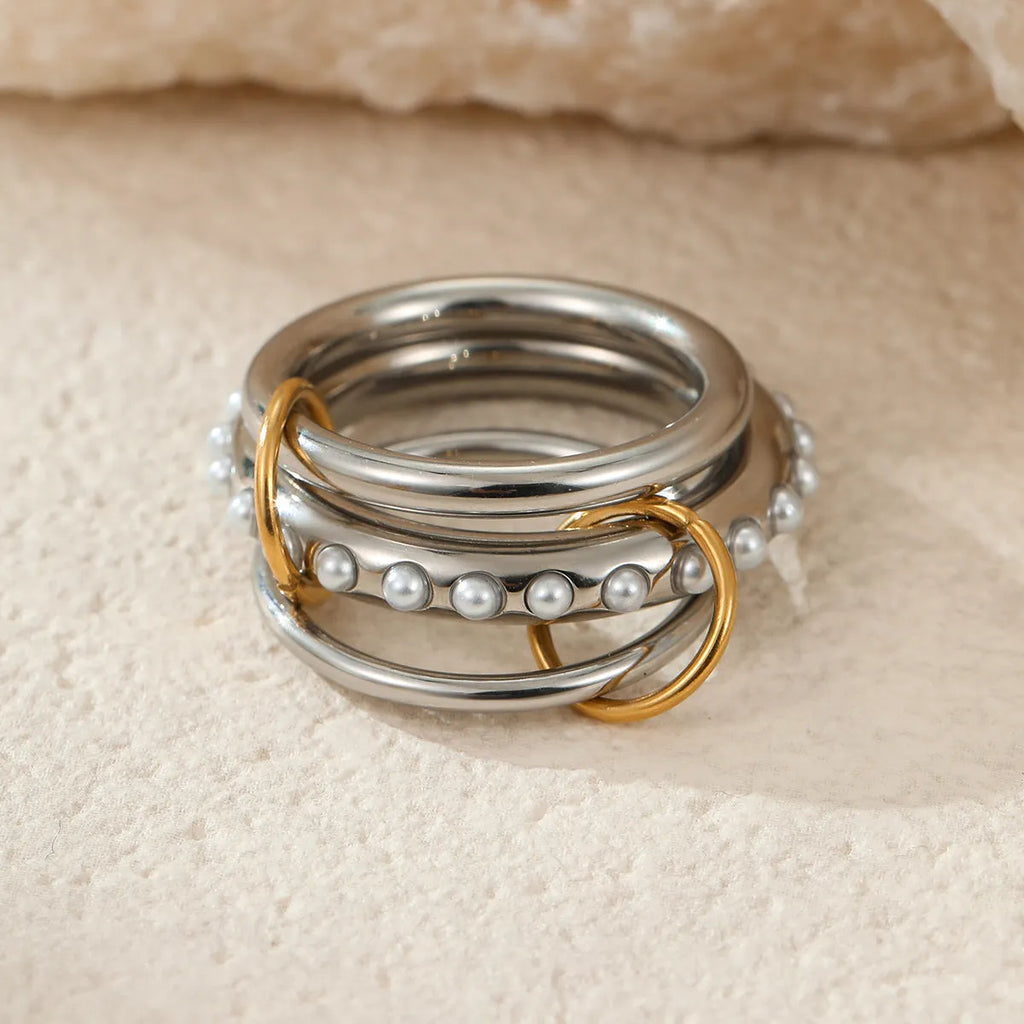 Stacked colour matching stainless steel rings with 18K gold electroplating in exaggerated jewellery styles